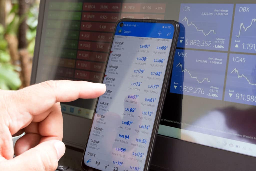 Harte Hanks Nasdaq Listing, touching touchscreen of stock market quotes