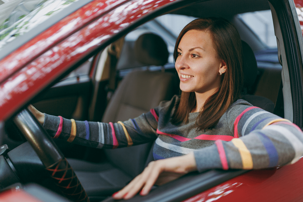 Lady driving a red car