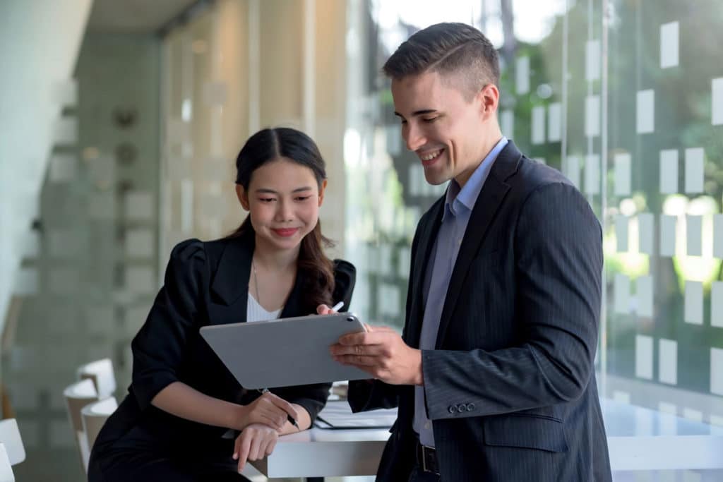 Two office workers looking at iPad