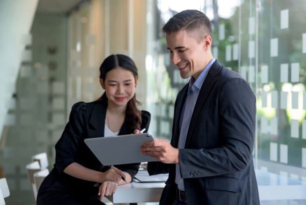 Two office workers looking at iPad