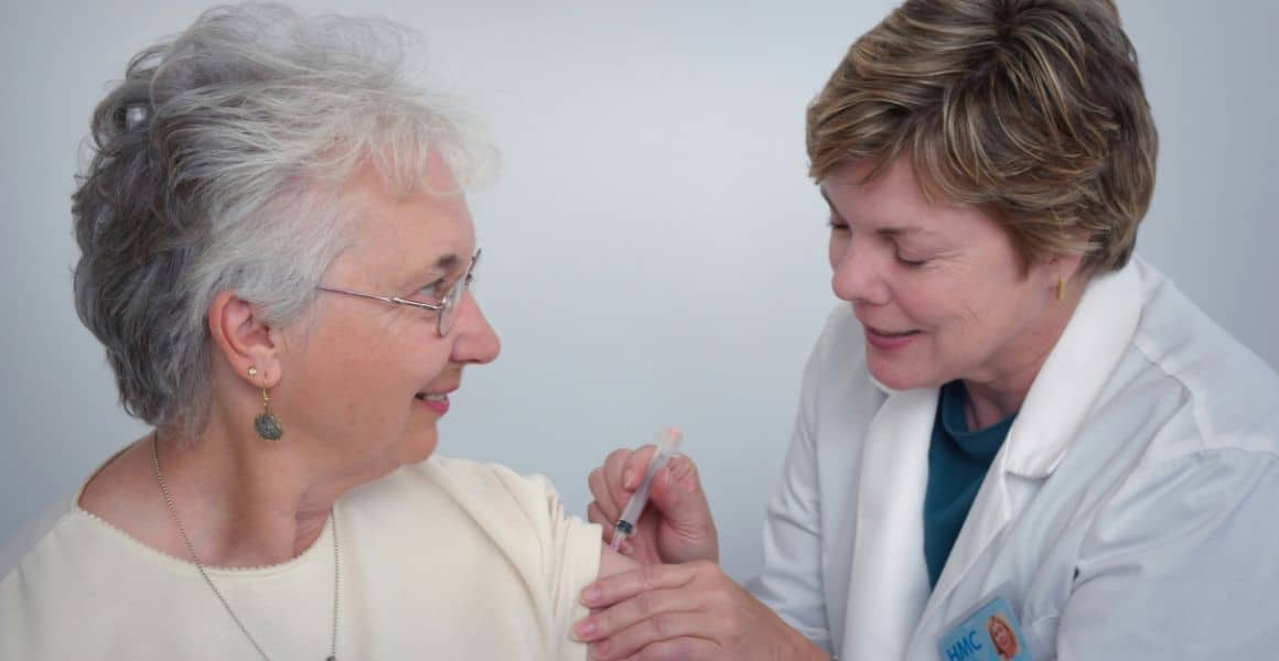 A woman supporting an elderly patient.