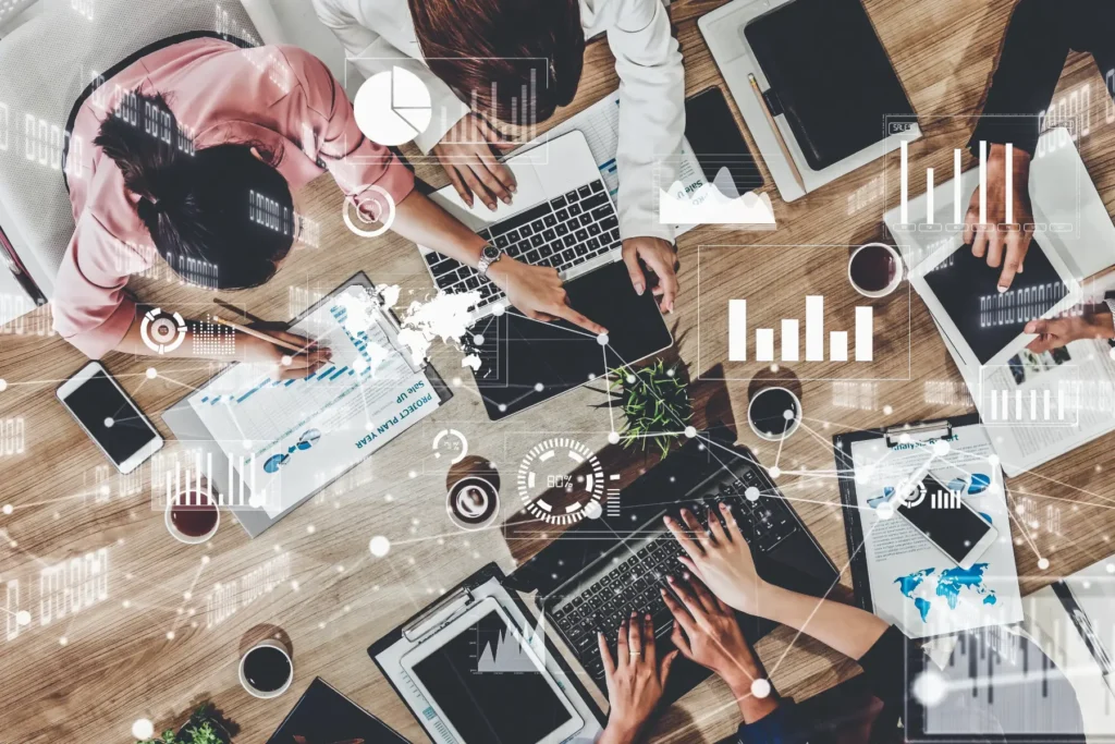 A team collaborates on a digital transformation strategy, using data analytics, AI-driven insights, and cloud-based digital tools to drive business growth and improve customer experience.