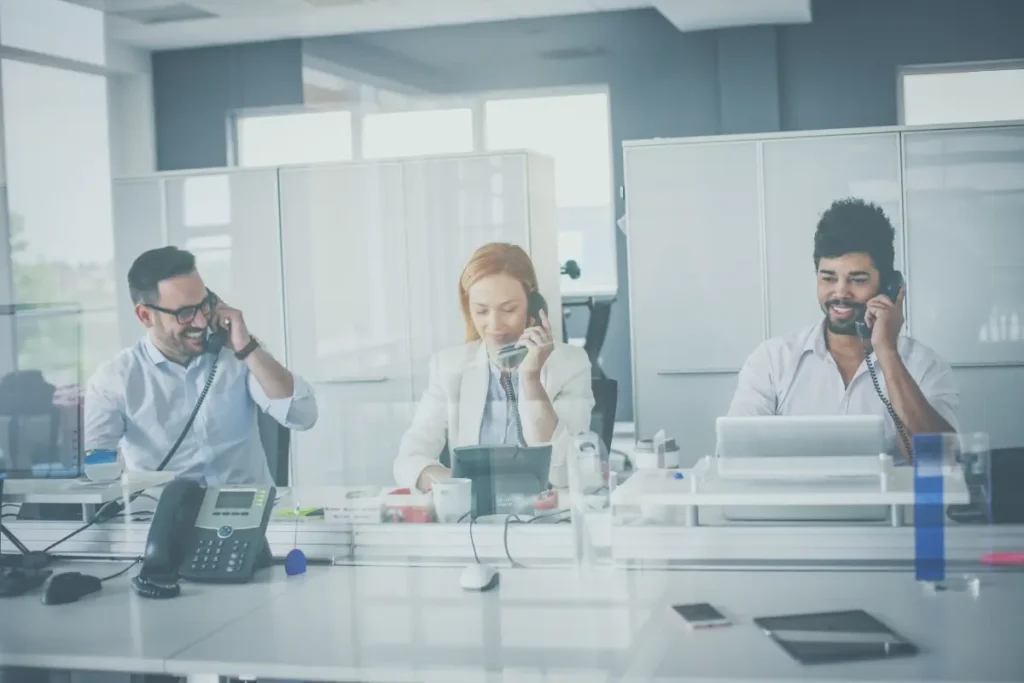 A team of professionals engaged in outsourced inside sales and lead generation activities within a modern office. This image represents the effective strategies used by lead generation companies and inside sales agencies, emphasizing the importance of inside sales outsourcing and inside sales services. The team is focused on providing comprehensive inside sales solutions that drive results for businesses, showcasing the power of outsourcing inside sales through leading inside sales outsourcing companies.