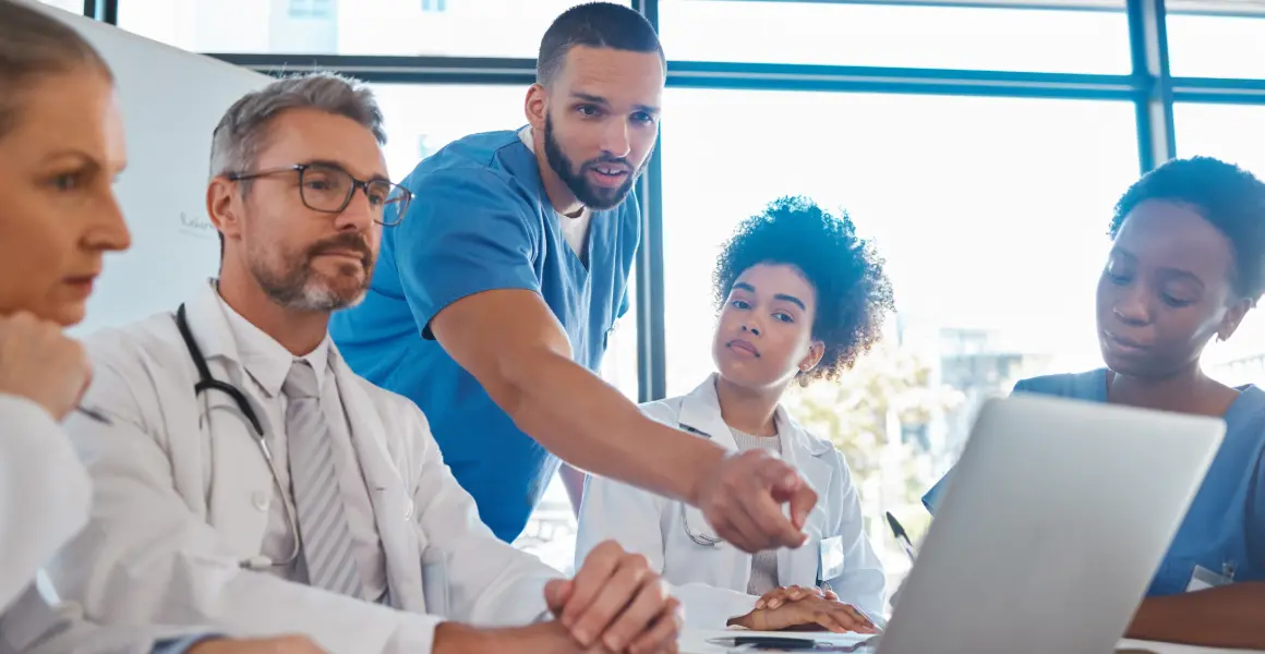 Group of healthcare professionals discussing data analytics in healthcare, focusing on the role of healthcare data companies in enhancing patient outcomes. The image highlights the significance of data analytics in the pharmaceutical industry for innovative healthcare solutions.