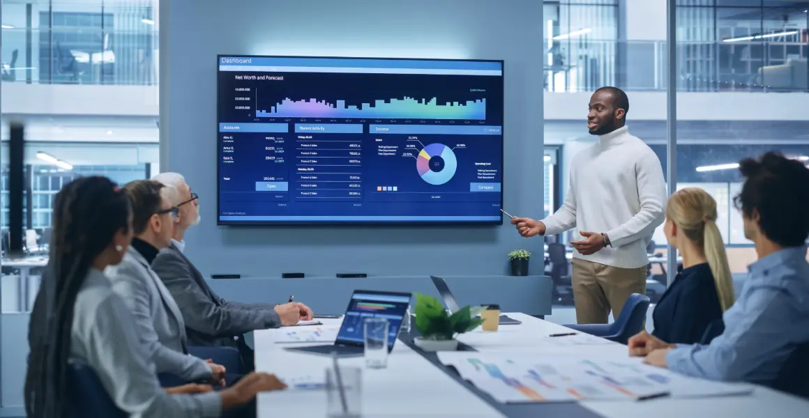 Healthcare team analyzing data on a large screen, demonstrating the role of healthcare data analytics companies in overcoming challenges in the data analytics in pharmaceutical industry. The image reflects the strategic use of data analytics in healthcare to improve security and integration.