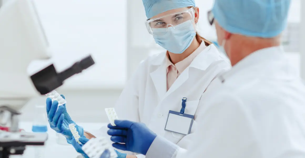 Scientists discussing predictive analytics in healthcare data companies, emphasizing the impact of data analytics in healthcare, including the pharmaceutical industry. The image highlights future trends in healthcare data analytics, such as drug discovery and personalized medicine.