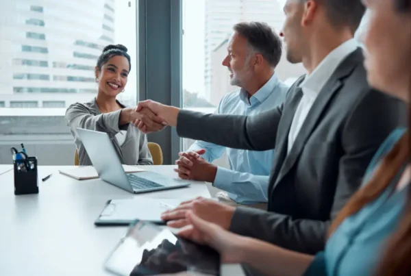 Building a collaborative partner marketing program in a professional meeting setting. Team discussing scalable partner strategies and ensuring marketing success.