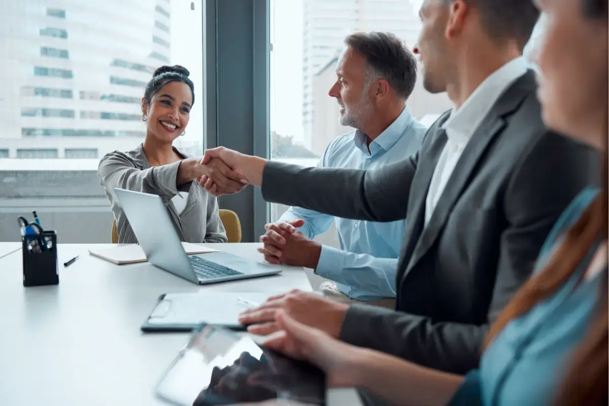 Building a collaborative partner marketing program in a professional meeting setting. Team discussing scalable partner strategies and ensuring marketing success.